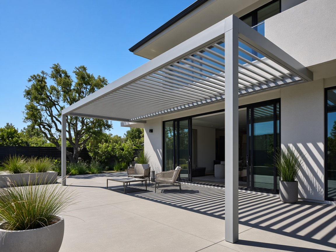 Modern louvered aluminum pergola casting linear shadows over a patio lounge